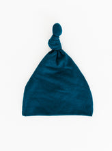 Load image into Gallery viewer, a full view of our Top Knot Hat for babies 0-3 months in Midnight Teal blue