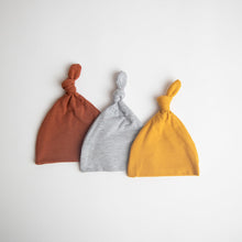 Load image into Gallery viewer, top knot baby hats in the colour rust, light grey and mustard