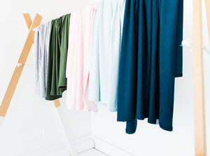our collection of swaddle blankets displayed side by side