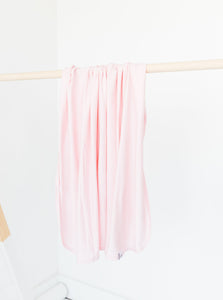 our bamboo stretch swaddle blanket in light pink