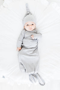 baby boy wearing our knotted baby gown in heathered grey and top knot hat in heathered grey