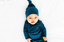 Load image into Gallery viewer, baby boy wearing our knotted baby gown and top knot hat in midnight teal