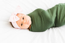 Load image into Gallery viewer, baby girl wrapped in our moss green swaddle blanket paired with our light pink headband