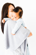 Load image into Gallery viewer, a mom holding her baby boy with our heathered grey swaddle blanket drapped over her shoulder