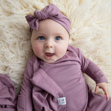 Load image into Gallery viewer, Baby wearing our mauve purple knotted gown, swaddle and headband
