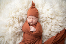 Load image into Gallery viewer, Swaddle Blanket and Top knot baby hat in the colour rust
