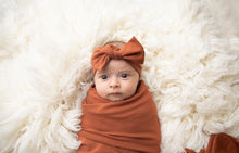 Load image into Gallery viewer, Baby wearing our top knot headband in Rust 